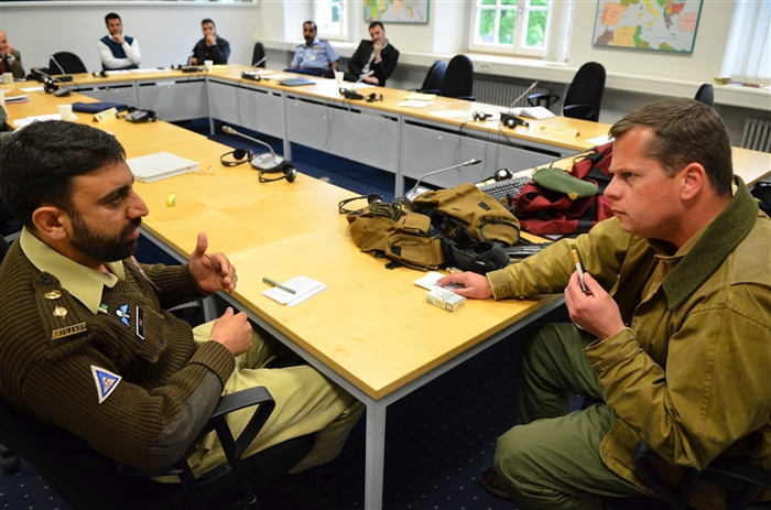Pakistani army Lt. Col Fiaz Khan attempts to negotiate with a warlord role-played by Tamir Sinai during an exercise at the George C. Marshall European Center for Security Studies May 16. The exercise tested the negotiating skills of participants in the Program in Advanced Security Studies at the Marshall Center. 