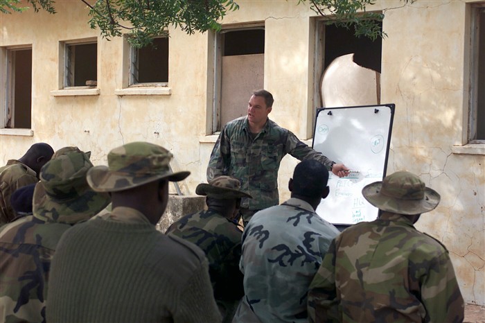 Prior to moving into field training, participants reviewed the principles of each training task. This 3rd SFG (ABN) instructor is reviewing the critical elements for conducting platoon level tactical operations in Sokoto, Nigeria. Official photo by PH1 Jim Hampshire, CINCLANTFLT.