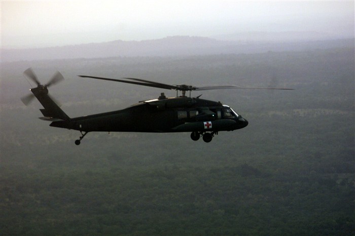 A medical evacuation helicopter assigned to the 30th Medical Brigade, U.S. Army, Europe flies over Nigeria at dusk. Medevac aircraft supported the tactical and live fire training through Phase I.  Official photo by PH1 Jim Hampshire, CINCLANTFLT. 