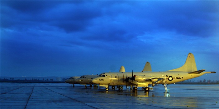 NAVAL AIR STATION SIGONELLA, Sicily &mdash; Three P-3C Orion aircraft belonging to the &#34;Tridents&#34; of Patrol Squadron 26 stand ready on a rain soaked airfield here Jan. 15, 2006. Originally designed as a land-based, long-range, anti-submarine warfare patrol aircraft, the mission of the P-3C has evolved to include surveillance of the battle space at sea or over land. VP-26 is currently on a six-month deployment supporting maritime patrol operations and the Global War on Terror. (Navy photo by Petty Officer 1st Class John Collins)