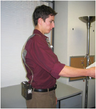 Employee wearing an air sampling pump and sorbent tube.