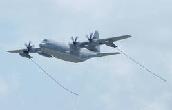 <p>
	A KC-130J Hercules extends its two refueling hoses during a simulated aerial refueling</p>