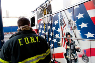 FDNY firefighter standing next to apparatus