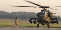 Apache being directed to land on landing pad