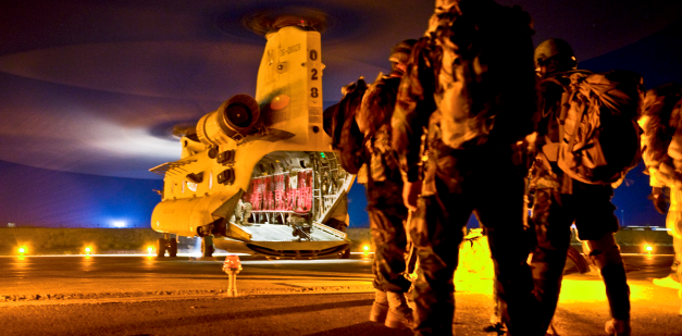 soldier waiting to board a chinook helicopter