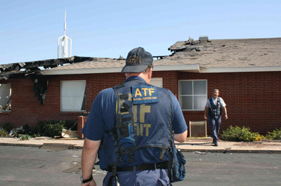 ATF National Response Team (NRT) members check the site of a fire at the Church of the Latter Day Saints in Tolleson, AZ.