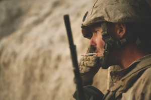 U.S. Marine Corps Sgt. Deacon Holten, a squad leader with 2nd Battalion, 8th Marine Regiment, smokes a cigarette after an attack at Patrol Base Bracha in the Garmsir district of Helmand province, Afghanistan, Oct. 9, 2009. (Photo courtesy of U.S. Marine Corps)