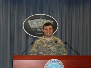 Photo of Soldier in uniform standing at Pentagon podium