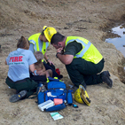 Rescue crews from the Ozark-St. Francis National Forest attend to three-year-old Landen Trammel whom they found Wednesday, Sept., 12 in Stone County, Ark. From left are Jamie Martin, Carol Swboni and Bradley Taylor who spotted the toddler playing in a mud puddle. Photo credit: Courtesy of Fox16.com