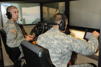 Left, Pvt. Emmitt Kauffman and Pvt. Cristopal Reyes, both with the 235th Engineer Sapper Company from Petaluma, Calif., train on the simulated Mine Protected Clearance Vehicle or "Buffalo" at the Virtual Clearance Training Suite, Sept. 18, 2012, at Fort Leonard Wood, Mo.