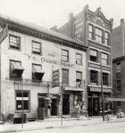 Picture of the first US Mint building which has the date 1792 and the words "Ye Olde Mint" on its front exterior.