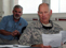 Army Maj. Loren Adams, right, the veterinary officer for the Iowa National Guard's 734th Agribusiness Development Team, reviews a document while Dr. Jim McCord, the U.S. Department of Agriculture veterinarian 