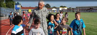 U.S. Army Europe commander Lt. Gen. Mark Hertling walks around the track with Patrick Henry Elementary School students Tuesday morning after he and his wife kicked off 