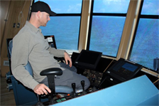 Third Mate Morgan Williams operates the drag arms of the U.S. Dredge Wheeler, which scoop up material from the seabed much like a giant vacuum cleaner.