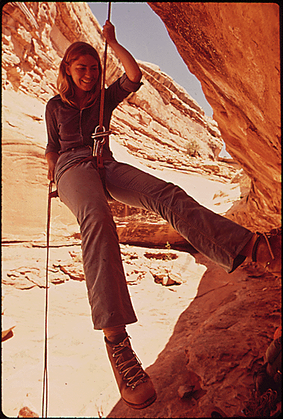 Woman repelling at Chimney Rock.