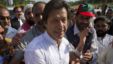 Imran Khan, cricketer-turned-politician and head of Pakistan Tehreek-e-Insaf (PTI) is surrounded with supporters as he leaves to lead a peace march against U.S. drone strikes from Islamabad to South Waziristan, October 6, 2012. 