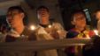 Tibetan exiles hold ceremonial scarves tied together as they participate in a candlelit vigil after reports of another self-immolation in Tibet, in Dharmsala, India, Oct. 5, 2012.