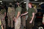 Lance Cpl. James R. Kerr, Chemical, Biological, Radiological and Nuclear Defense specialist, CBRN Platoon, 15th Marine Expeditionary Unit, demonstrates the proper removal of mission oriented protective posture gear to Marines from Weapons Company, Battalion Landing Team 3/5, 15th MEU, during a class on CBRN defense aboard the USS Peleliu, Oct. 4. The 15th MEU's CBRN Defense Platoon is spending an entire month preparing the 2,400 servicemembers that make up the MEU on how to properly operate in contaminated environments. The 15th MEU is currently embarked as part of the Peleliu Amphibious Ready Group, while they serve as the nation's rapid-response sea-based Marine Air Ground Task Force for Western Pacific Deployment 12-02. Kerr, 19, is from Boston.