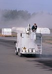 Water is sprayed on ash-covered taxiways and runways, Anchorage International Airport