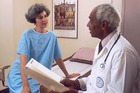 Doctor and patient in exam room. - Click to enlarge in new window.