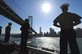 Navy sailors and Marines man the rails aboard the amphibious assault ship USS Makin Island as the ship passes under the San Fransisco-Oakland Bay Bridge en route to San Francisco for San Francisco Fleet Week 2012, Oct 3, 2012. San Francisco Fleet Week is scheduled from Oct. 3-8. U.S. Navy photo by Chief John Lill