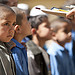 An Afghan school boy waits for his new school supplies