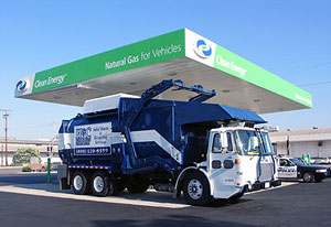 Photo of a large truck stopped at a gas station that reads 'Natural Gas for Vehicles.'