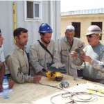 Staff Sgt. Joe Campos (right), with Infrastructure Training Advisory Group, gives on the job training to Afghans on the proper use of power tools. (Photo by Cpt. Jose Rocha)