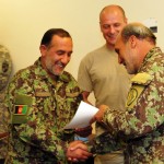 KABUL, Afghanistan – Afghan National Army Brigadier General Said Qasim presents Col. Nazar Mohammad Safi of the ANA his certificate showing he completed the frequency management class at the Afghan Communications Support Unit, June 2. (U.S. Navy photo by Mass Communications Specialist 3rd Class Jared E. Walker)