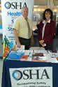 OSHA Area Director Albert D'Imperio, and OSHA Compliance Assistance Specialist Isabel DeOliveira work a resource table at the at Bi-national Health Week event. View the slideshow for more images and captions.