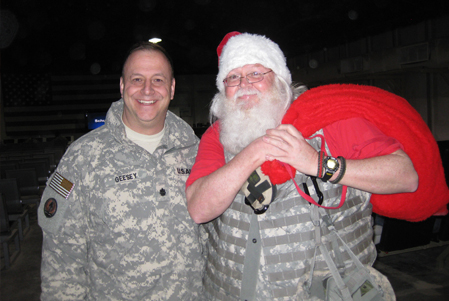 MC4 Product Manager Lt. Col. William Geesey meets up with Santa Claus at the Ali Al Salem Air Base Passenger Terminal in Kuwait in between flights