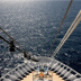 Bow of ship cutting through calm ocean waters.