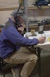 Beardmore Camp helicopter coordinator, Curt LaBombard, plans the next day's flight schedule with McMurdo Station using an Iridium phone.