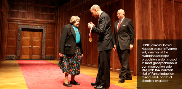 USPTO director David Kappos presents Yvonne Brill, inventor of the hydrazine resistojet propulsion systems used in most geosynchronous communication satellites, with the Inventors Hall of Fame induction medal. NIHF chairman Edward Gray looks on.
