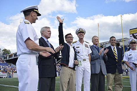 Lt. Brad Snyder, winner of two gold medals and one silver medal in the 400, 100 and 50-meter freestyle competitions at the 2012 Paralympic games, waves to his fans and supporters during a football game at Navy-Marine Corps Memorial Stadium. Snyder, an Explosive Ordnance Disposal (EOD) officer and 2006 U.S. Naval Academy graduate, was recognized by the Naval Academy Athletic Association for his achievements during a NCAA football matchup between the Midshipmen and the San Jose State Spartans. On Sept. 7, 2011 Snyder lost his sight while when an improvised explosive device (IED) detonated in his face while he was coming to the aid of Afghan soldiers who were victims of another IED. One year later, on Sept. 7, 2012, Snyder proved his resilience by competing and winning the 400-meter freestyle gold medal in the Paralympics.  U.S. Navy photo by Mass Communication Specialist 1st Class Peter D. Lawlor (Released)  120929-N-WL435-434