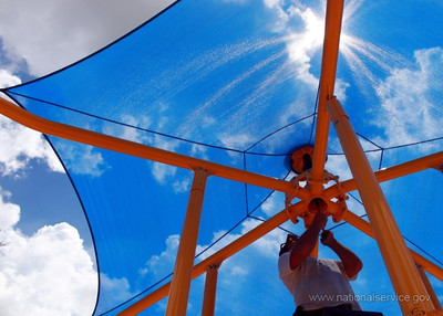 A volunteer puts together a piece of playground equipment at a KaBOOM! build in Ruth Rothkopf Park in Lauderhill, FL. (Photo courtesy of KaBOOM!)