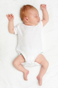 Photo: Infant sleeping on back