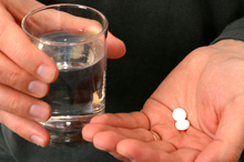 Photo of aspirin in a hand.