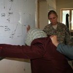 KANDAHAR, Afghanistan -- Sgt. Brittany Deters, a Soldier with the Female Engagement Team for the 58th Military Police Company attached to 1st Squadron, 10th Cavalry Regiment, 2nd Brigade Combat Team, 4th Infantry Division, coaches female Afghan Uniformed Police who are practicing searching a detainee at Camp Nathan Smith Mar. 28. The FET hosted a day of training for the female AUP in which they were taught techniques of searching a detainee, rule of law and first aid. (U.S. Army photo by Sgt. Ruth PagÃ¡n, 2nd Brigade Combat Team, 4th Infantry Division, PAO)