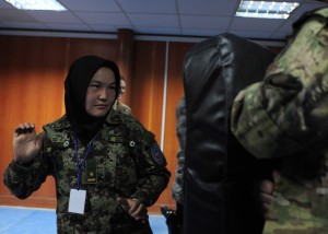 Afghan air force Lt. Sakina, prepares to strike a simulated attacker a during a woman's self-defense class at Kabul International Airport, Feb. 29, 2012. Advisers from the 439th and 738th Air Expeditionary Advisory Squadrons recently held the training was held to prepare the students physically and mentally for what they could experience if placed in a dangerous scenario. (Photo by Staff Sgt. Nadine Barclay)