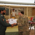 Col. Robin Fontes, the Regional Command – North commander, presents a certificate to an Afghan National Policeman at Regional Training Center Konduz, Konduz Province, June 28, during a transfer ceremony.