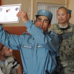 A graduation of the Afghan National Police training center at Training Support Center Shaheen, Balkh Province, shows off his certificate of completion July 12 during a ceremony.