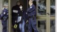 French police officers stand guard at the entrance of a building in Strasbourg, France, Saturday Oct. 6, 2012, where  a suspect was shot dead after firing at police.