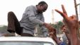 Ugandan opposition party leader Kizza Besigye shakes hands with supporters before being arrested on September 4, 2012 in Kampala, Uganda.