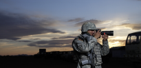 Army Public Affairs Specialist taking pictures at sunset