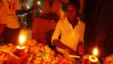 A Ugandan woman shops at  a kiosk in candle light in Kampala. (file photo)