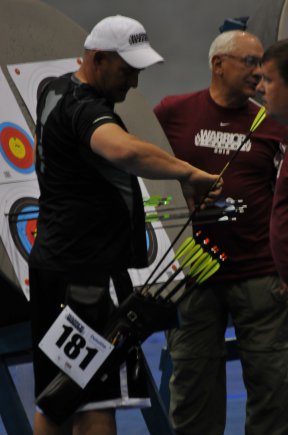 Retired Staff Sgt. Jesse White recovers his arrows from his target after judges total his score for the round during the Warrior Games May 2, 2012, at Colorado Springs, Colo.