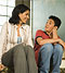 Mother and son sitting on staircase