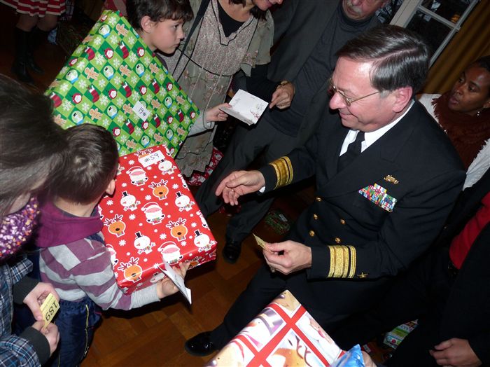 STUTTGART, Germany – Navy Rear Adm. Charles Martoglio, U.S. European Command chief of staff, presents gifts  donated by volunteers from the Stuttgart military community to local German children during a ceremony held at the Stuttgart-Feuerbach Rathaus Dec. 20.  More than 200 children's wishes were fulfilled from the "Wishmas" trees placed  in participating buildings on Patch and Kelley barracks. The collected gifts  were provided to German children in the Stuttgart Youth Welfare program,  including foster children, refugees, children in group homes and children in  low-income families. 