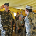 An Afghan Border Police recruit, right, salutes French Gendarmerie Brig. Gen. Christian Dupouy, left, commander of Assistant Command General Police Transition Group under NATO Training Mission - Afghanistan, before receiving a certificate of completion during the recruits' initial police training course graduation ceremony at the Spin Boldak Police Training Center, May 31, 2012.